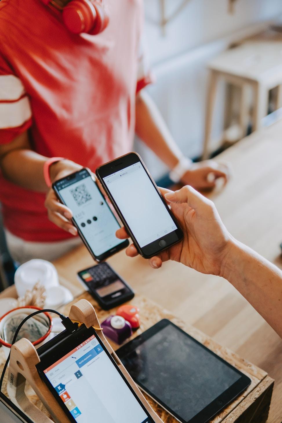 Customer paying with a mobile phone at a retail checkout counter